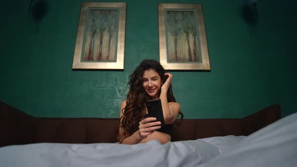 Sexy Girl Taking Selfie Mobile Phone Bed. Beautiful Woman Using Phone in Bedroom alt