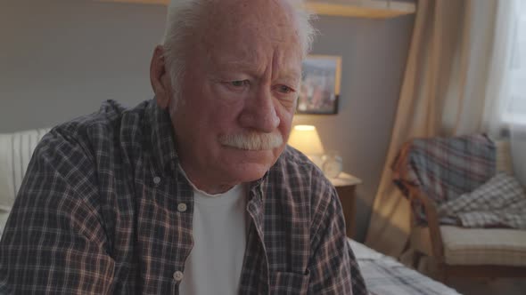 Elderly Man Watching TV in Bedroom alt