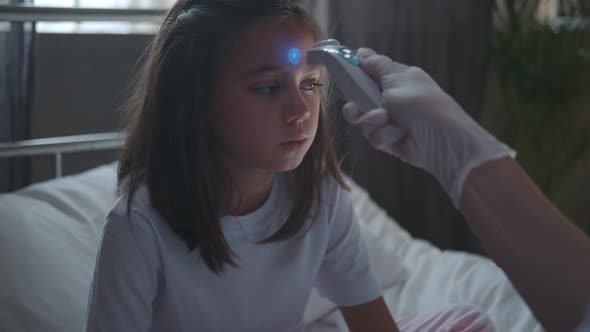Nurse Measures the Temperature of a Sick Little Girl 