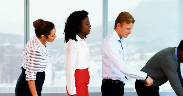 Executives waiting in a queue to drink water alt