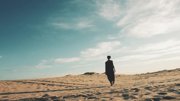 Young Beautiful Woman Walking in Desert Landscape