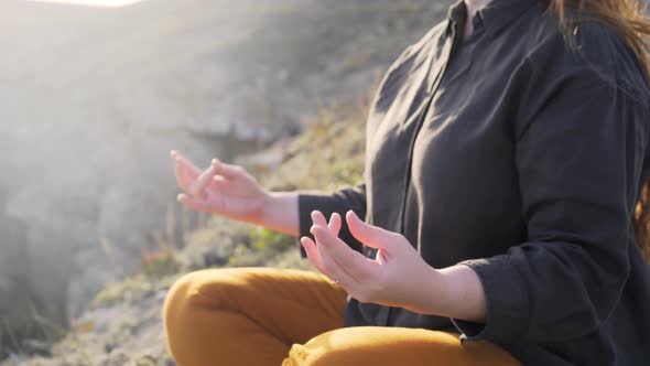 Faceless Woman Meditates at Nature in Backlit