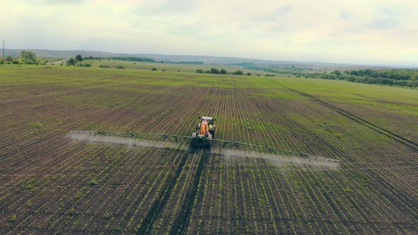 Aerial View Farm Machinery Spraying Insecticide To the Green Field, Agricultural Natural Seasonal alt