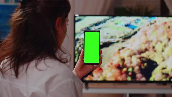 Young Adult Looking at Smartphone with Green Screen alt