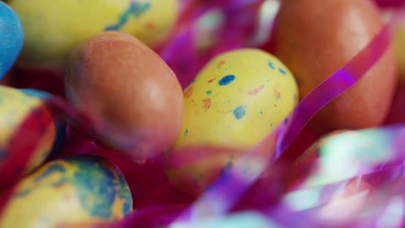 Rotating shot of colorful Easter candies on a bed of easter grass  alt