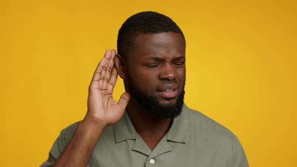 Curious African American Man Keeping Hand Near Ear Trying To Overhear Information alt