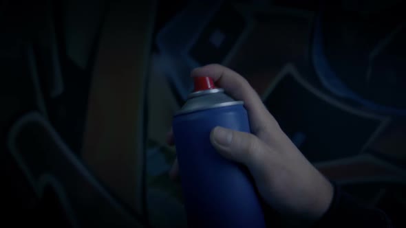 Man Using Spraypaint For Graffiti Art alt