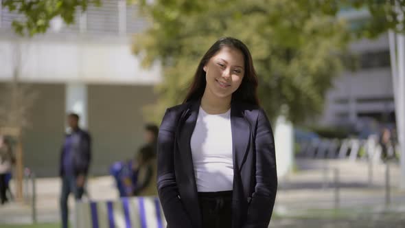 Beautiful Young Woman Posing at Camera Outdoor alt