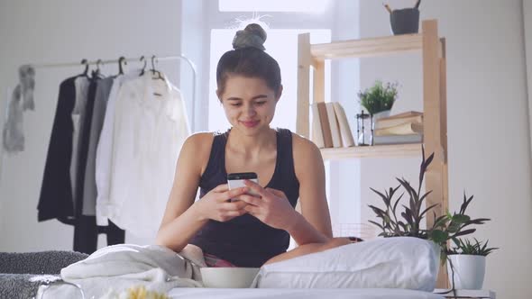 Happy Caucasian Girl Chatting with Boyfriend Using Smartphone in Slowmotion alt