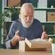 Aged Older Man Unpacking Carton Box Satisfied with Internet Store Purchase - VideoHive Item for Sale