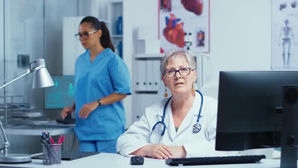 Experienced Senior Lady Doctor Smiling at the Camera alt