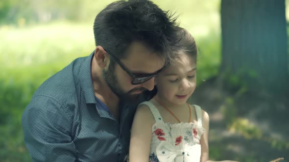 Family Father With Daughter Reading Book. Child Interesting Book. Child Preschool Education. alt