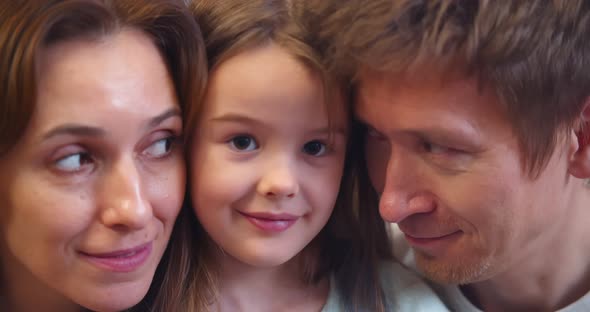 Close Up Portrait of Happy Smiling Mother Father and Little Daughter alt