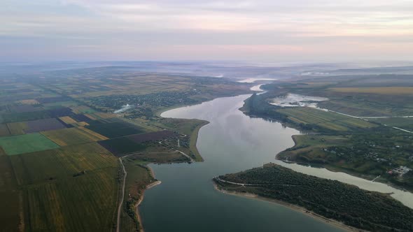 Aerial drone view of the Duruitoarea natural reservation in Moldova. River and fog in the air, hills alt