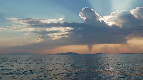 Sunset in Mesologgi Greece. Boat view of the sunset behind clouds and sea horizon. alt