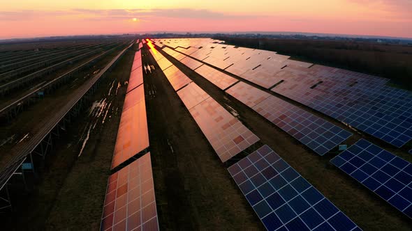 Aerial footage of Solar Energy Modules or Panels rows. Flying above Huge Photovoltaic alt
