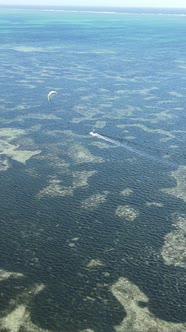 Tanzania  Vertical Video Kitesurfing Near the Shore of Zanzibar Slow Motion alt