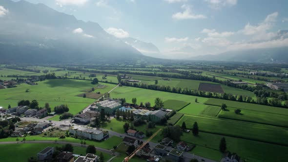 Aerial View of Liechtenstein with Houses on Green Fields in Alps Mountain Valley alt