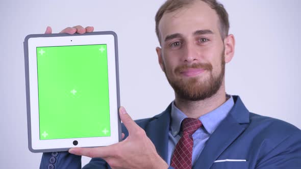 Face of Happy Bearded Businessman Showing Digital Tablet