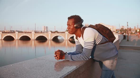 A Young Black Guy Stands in the Street Waiting for the Sunset