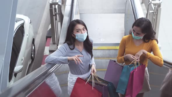 Asian woman wearing face mask. Happy woman with shopping bags