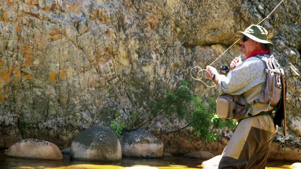 Fisherman fly fishing in river alt
