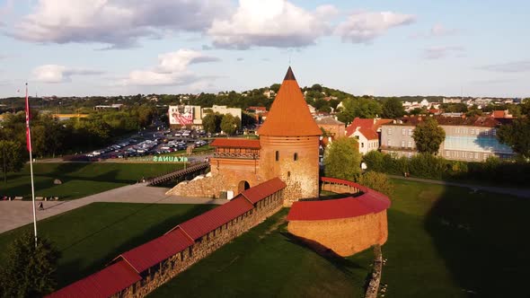 Aerial footage of Kaunas castle, situated in Kaunas old town, Lithuania in beautiful sunny evening. alt