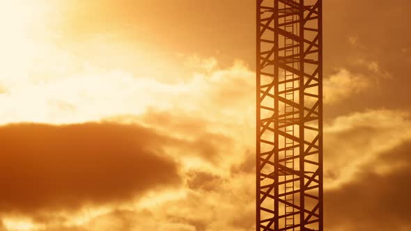 Ladder of Tower Crane Construction Site Sunset Light, Orange Sky Moving Clouds Morning or Evening alt