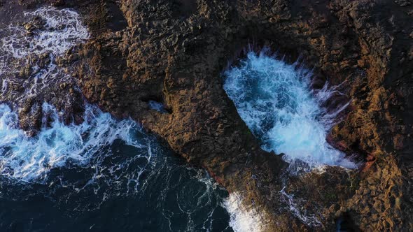 Sea Flowing Into Rock Pool And Against Coastline alt