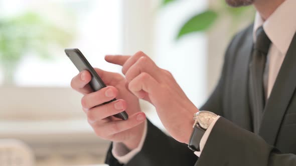 Close Up of Hands of Middle Aged Businessman Reacting to Failure on Smartphone alt
