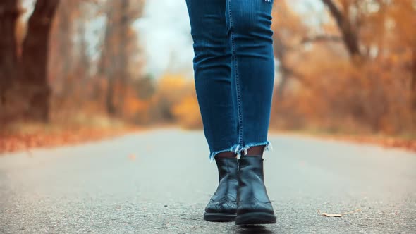 Woman Legs Walking On Fallen Leaves. Stylish Woman Legs In Leather Shoes Walking On Vacation Holiday alt
