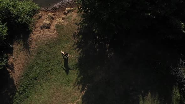 Girl Dancing On Riverbank In Forest Top View