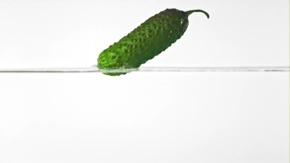 Super Slow Motion Cucumber Falls Into the Water with Splashes alt