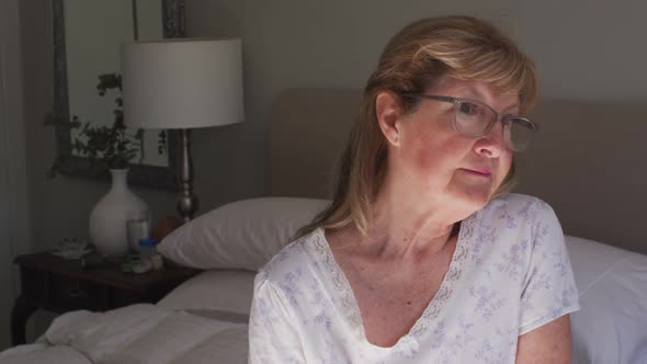 Thoughtful senior woman at home alt