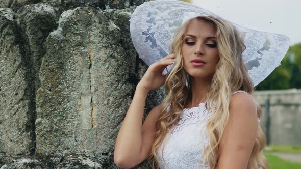 Modest Bride in a White Hat Looking at Camera alt