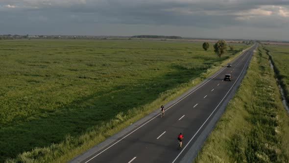 The Cyclist is Driving Fast on the Highway alt