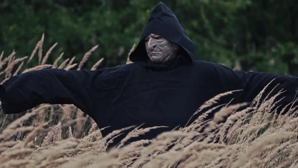 Spooky evil with horrorful face outdoors. Scary view of a black ghost appearing alt