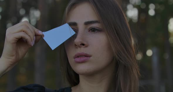 Portrait of a Caucasian Girl Holding Fragment of Broken Mirror alt