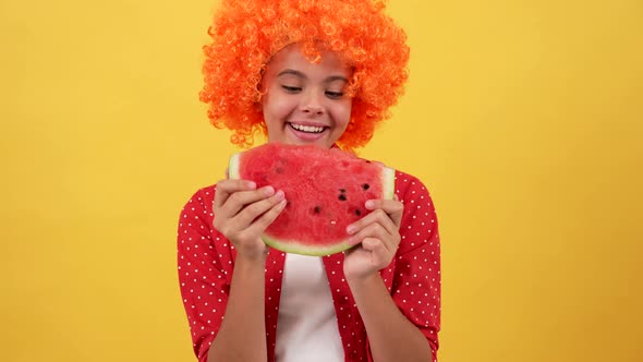 Happy Kid in Orange Hair Wig Eating Slice of Watermelon Fruit on Yellow Background Watermelon alt