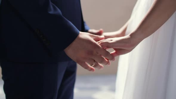 Bride and Groom Holding Hands for Their Wedding Close Up