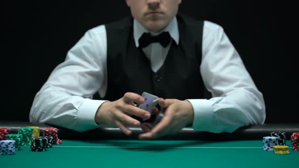 Experienced Croupier Shuffling Cards and Showing Ace Into Camera, Gambling alt