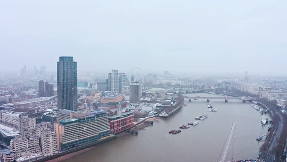 London snow aerial drone shot south bank waterloo bridge London eye alt