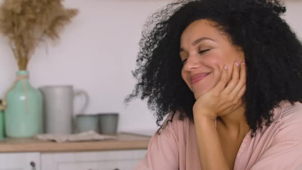 Cute African American Woman Communicates on a Video Call Using a Mobile Phone alt