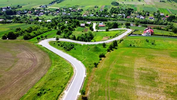 Aerial drone view of a flying over the rural agricultural landscape. alt