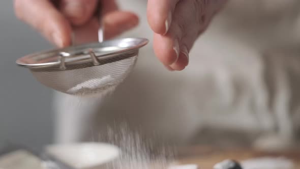 Powdered Sugar is Poured Onto Croissants alt