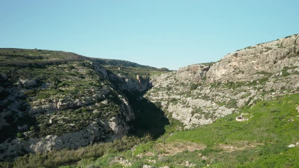 AERIAL: Flying In Canyon Near Magrr Ix-Xini Bay on Gozo Island in Malta alt
