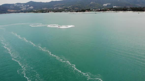 Anonymous Person Riding Water Scooter. Unrecognizable Tourist Riding Modern Water Scooter alt