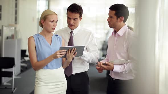 Business colleagues collaborating with use of digital tablet alt