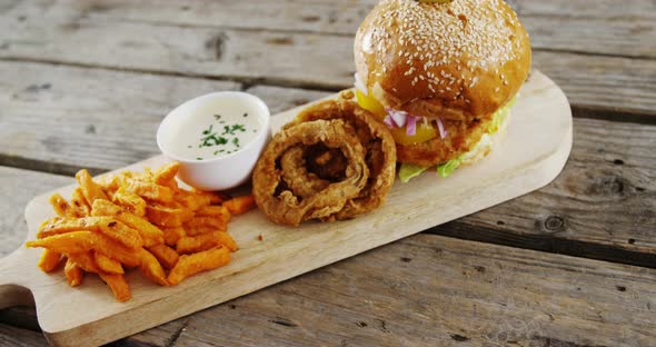 Snacks arranged on chopping board alt