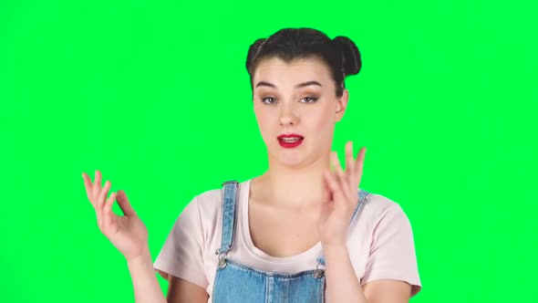 Girl with Two Hair-buns Claps Her Hands Indifferently Then Yawns on Green Screen. Slow Motion alt